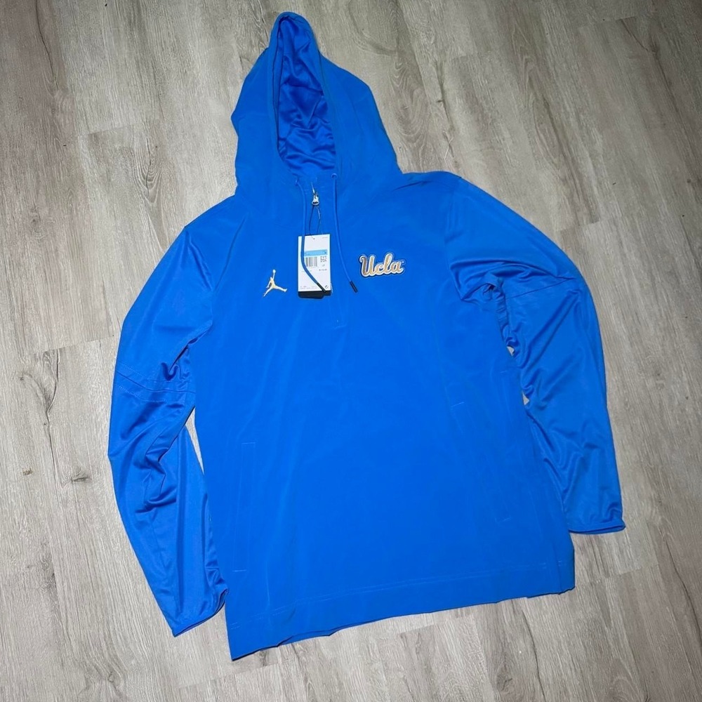 Jordan UCLA blue windbreaker hoodie with gold 'UCLA' text and gold Jumpman logo